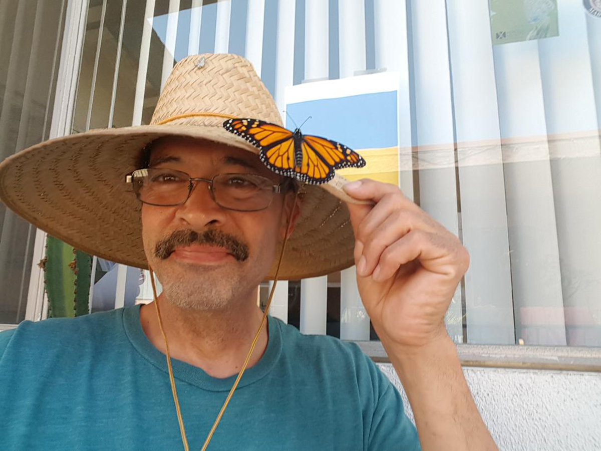 Xerces Society member Augustin Garnier with monarch butterfly on hat