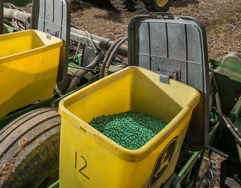 Pesticide-coated seeds in farming equipment