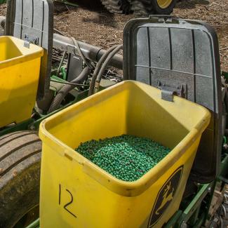 Pesticide-coated seeds in farming equipment